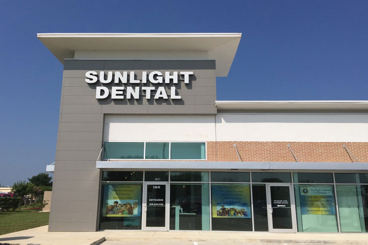 The image shows a dental clinic named  Sunlight Dental  with a sign that reads  Sunlight Dental.