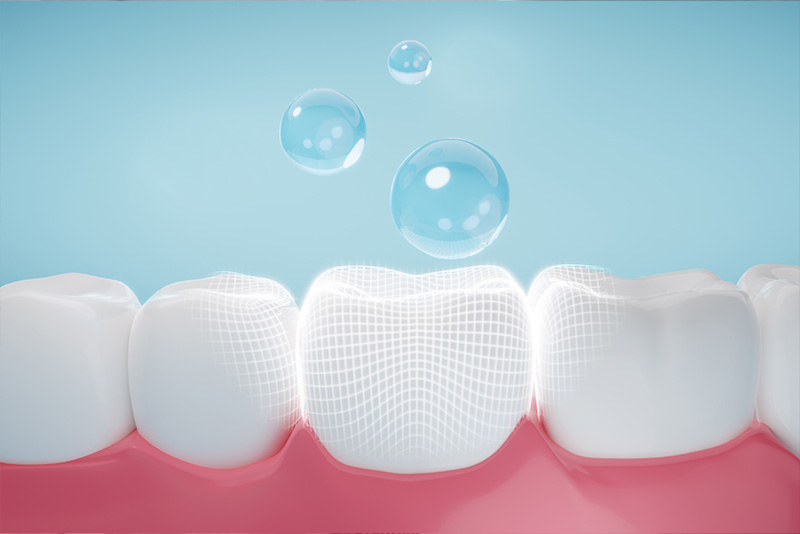 The image depicts a close-up of a row of white teeth with a glossy finish, set against a backdrop that transitions from blue at the top to pink at the bottom, giving an impression of a clean and healthy dental environment.